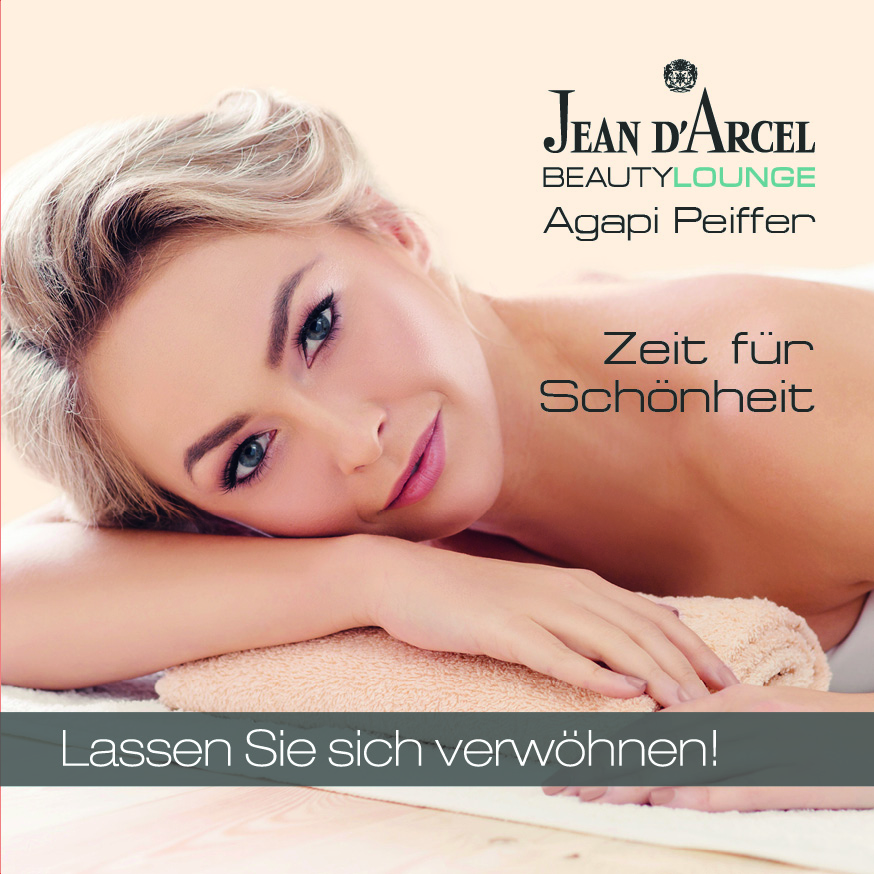 Eine jüngere und ältere Frau sitzen nebeneinander und lächeln in die Kamera